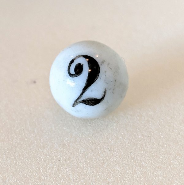 Rare numbered china with handpainted old fashioned "2" under a shiny glazed surface.  From an original game board with numbnered chinas 1-9. Typical as-made tripod spots from being glazed & fired.
