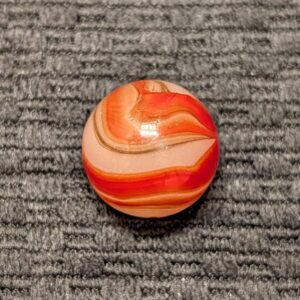 Shooter 3/4" AKRO Corkscrew of Twin Orange Corkscrews & Wispy Oxblood Tracer over a Moss Base